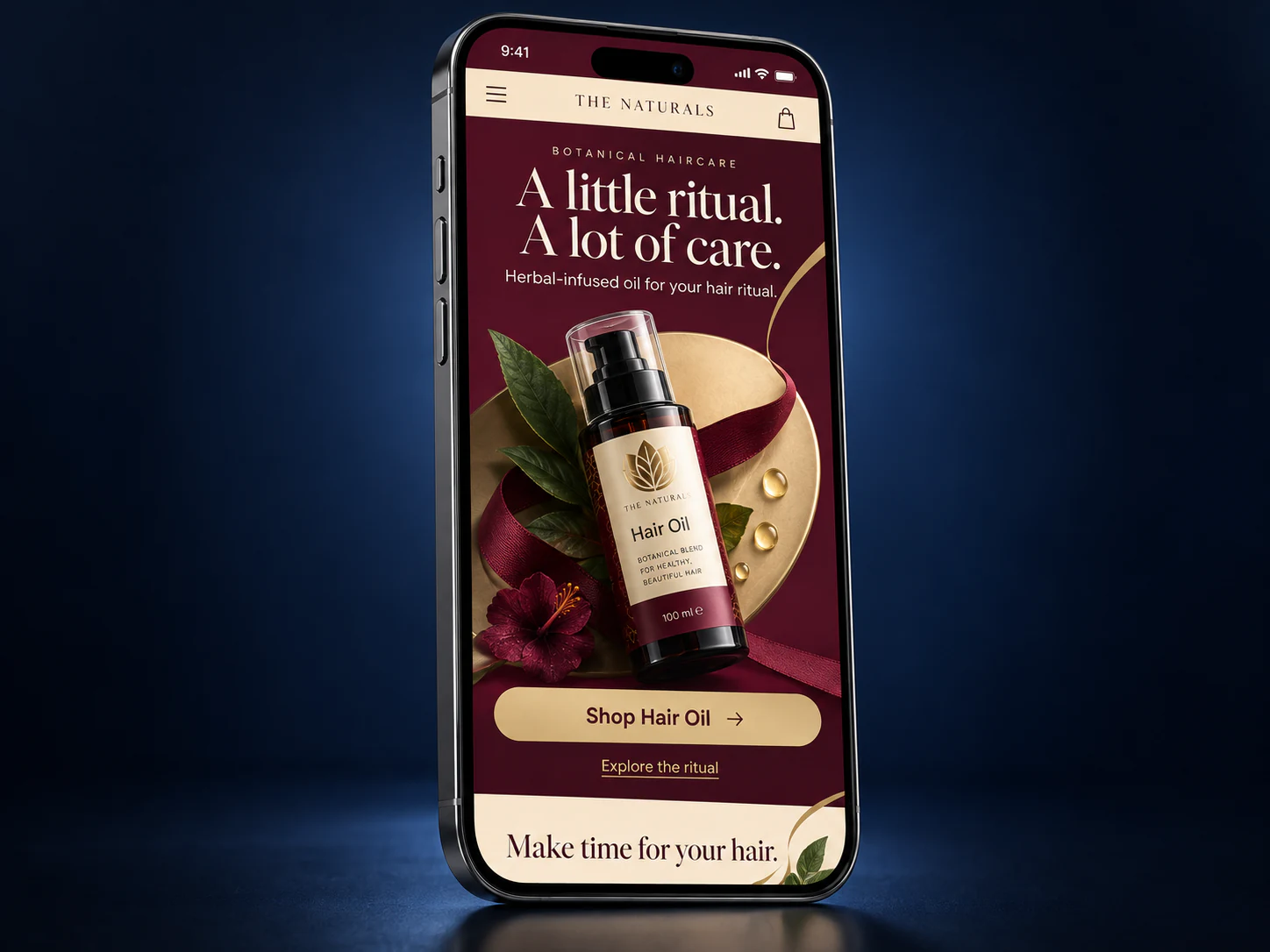 Burgundy and gold haircare mobile website on an iPhone against a navy studio background