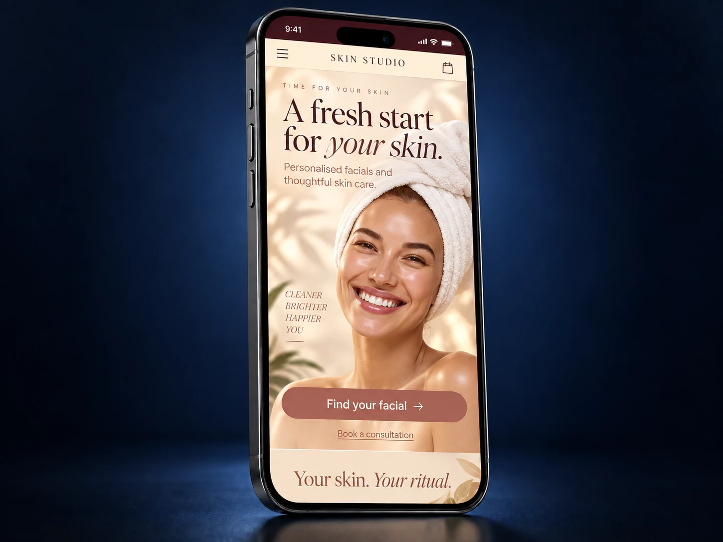 Peach and cream skin renewal mobile website on an iPhone against a navy studio background